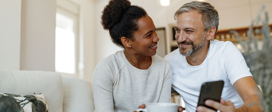 Couple Smiling at Each Other with a Phone